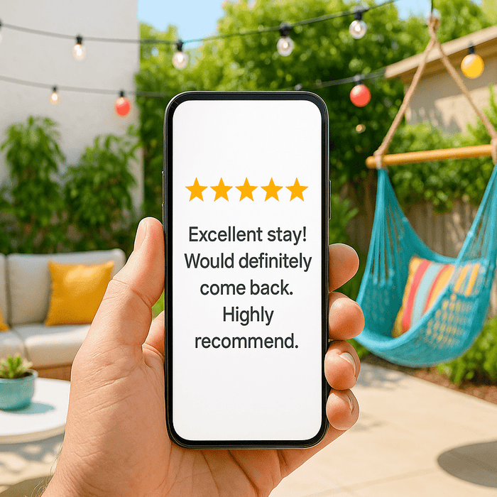 hand holding a cellphone with a cozy patio in the background