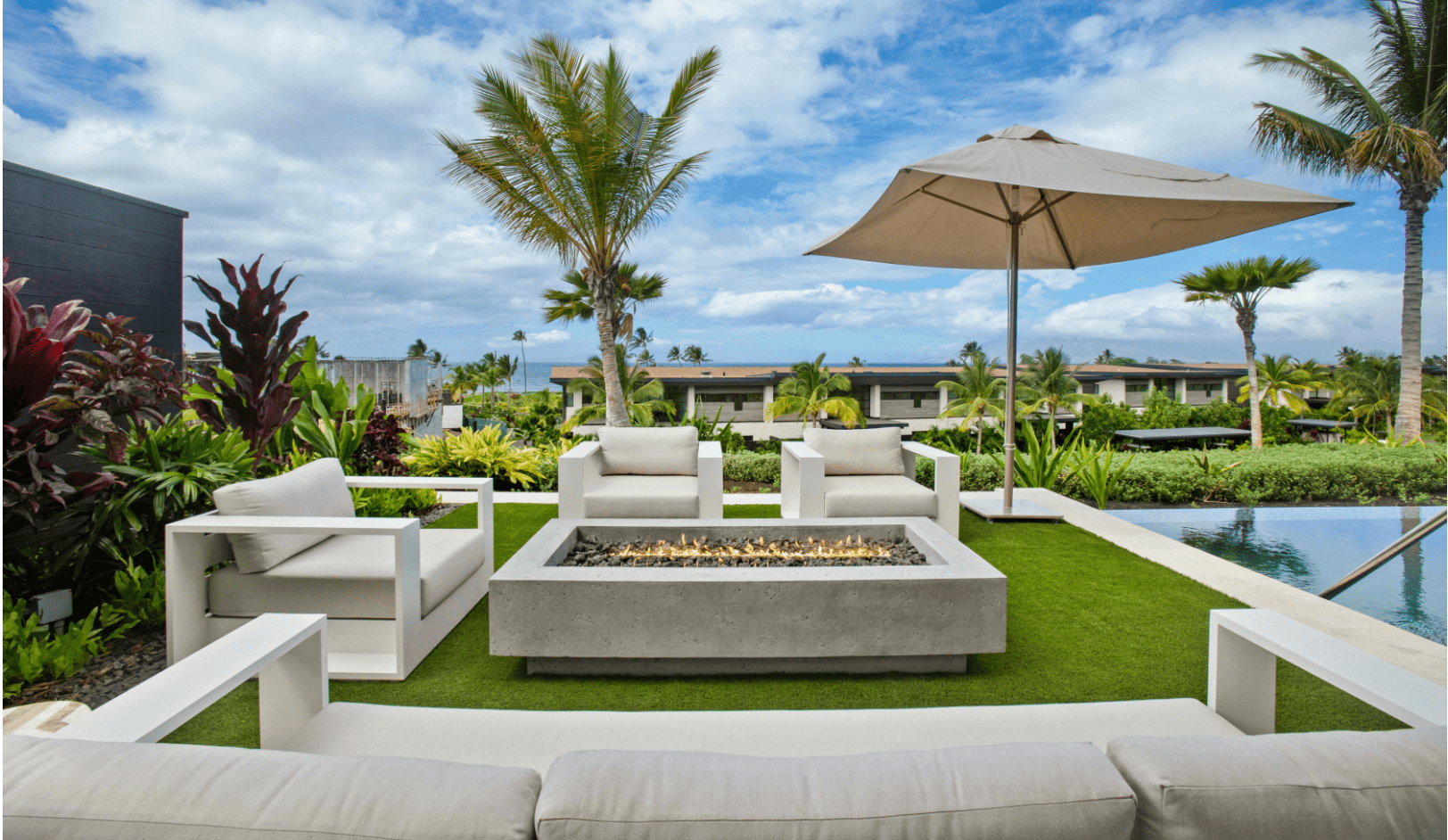 resort like outdoor seating furniture and umbrella