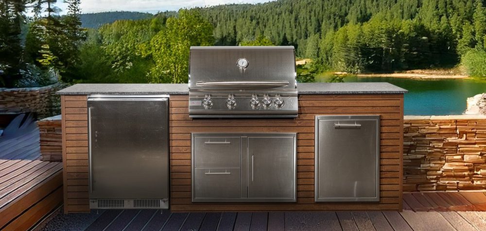 Outdoor kitchen island with a built-in stainless steel grill and black granite countertop overlooking a lake