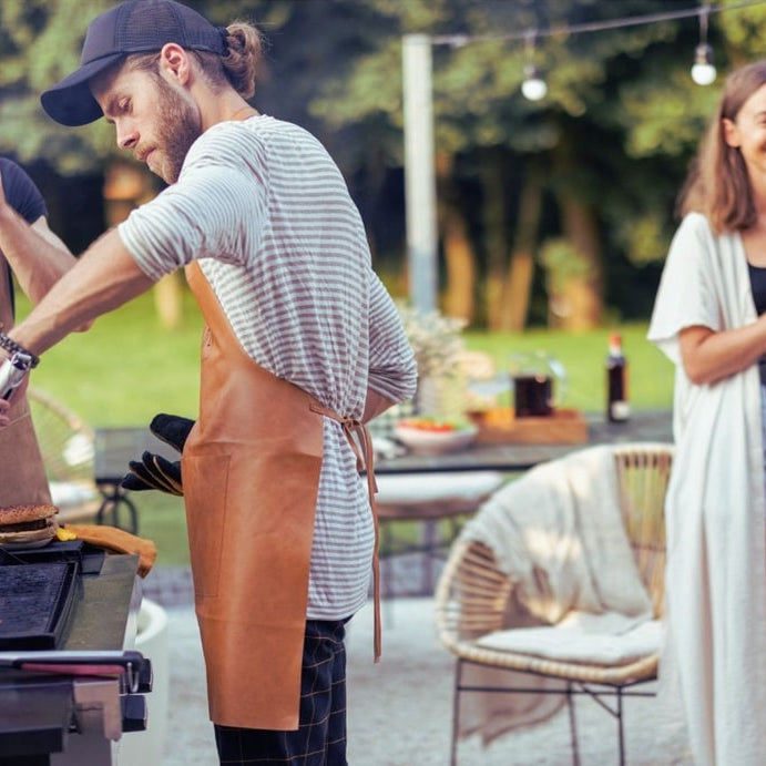friends cooking and chatting at a backyard