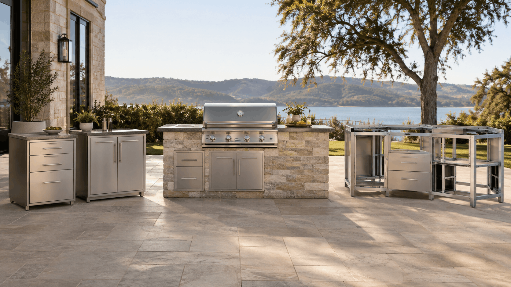 Standalone stainless steel cabinets, a stone-clad built-in grill island, and a bare metal frame kit side by side on a lakeside patio