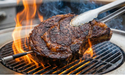 Arteflame Classic 40" fire pit grill searing steak over open flame