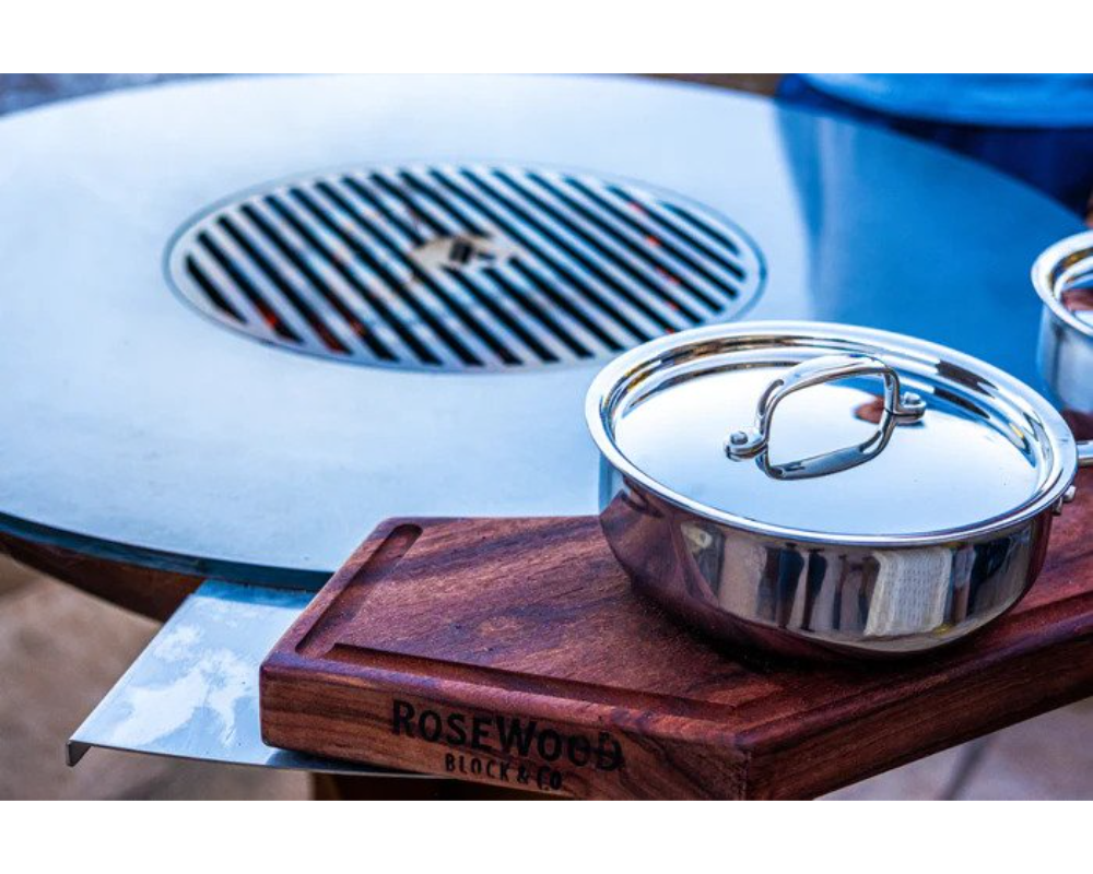 Arteflame Grill Prep Board with Rosewood cutting board and stainless steel pot on Arteflame brushed steel grill edge