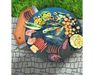 Arteflame Cherry Wood Cutting Board on Arteflame Grill overhead view with sausages, ribs, corn, and vegetables grilling