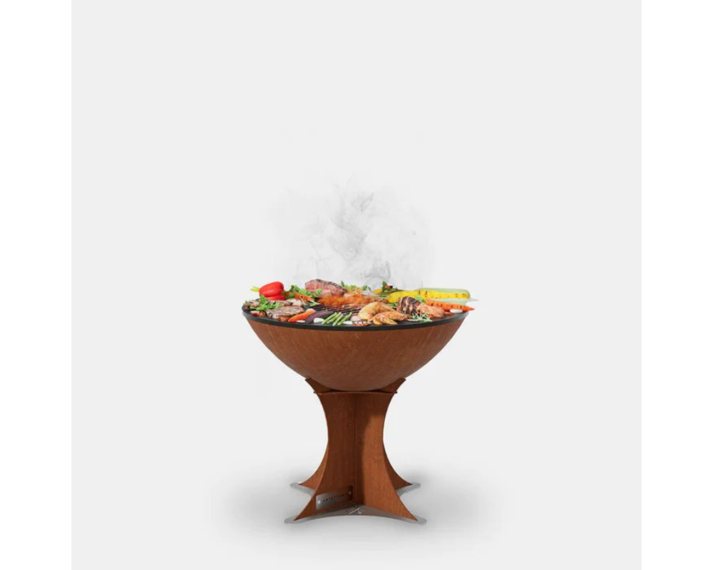 Arteflame Classic 20" Corten Steel Grill with Tall Euro Base grilling meat, shrimp, and vegetables on flat-top cooking surface
