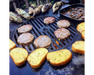Arteflame Classic 30" Grill cooking burger patties, garlic bread, corn, and mushrooms on flat-top steel surface over fire