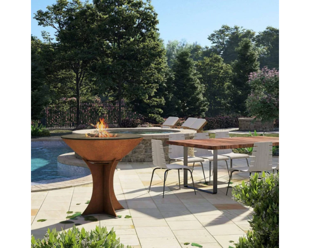 Arteflame Classic 40" Corten Steel Grill with Tall Euro Base on outdoor poolside patio with dining table setting