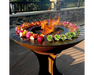 Arteflame Classic 40" Grill with Tall Euro Base grilling colorful vegetable and meat skewers around open center flame