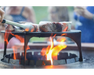 Arteflame Stainless Steel Grill Grate Riser elevating steaks over open flame in Arteflame fire pit grill center bowl