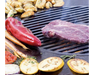 Arteflame Carbon Steel Grill Grate Insert with steak, red pepper, carrots, tomatoes, and zucchini on flat-top surface