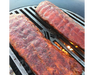 Arteflame Carbon Steel Center Grill Grate Insert grilling two full racks of seasoned BBQ pork ribs over open flame