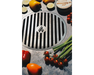 Arteflame Carbon Steel Center Grill Grate Insert surrounded by fresh tomatoes, peppers, zucchini, and green onions