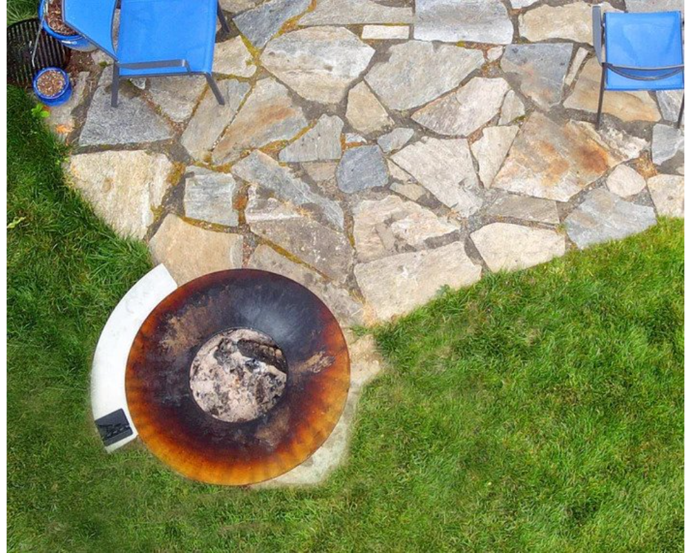 Arteflame Stainless Steel Side Warming Table shelf attached to Arteflame Grill overhead view on stone patio in backyard