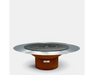 Arteflame round outdoor grill with stainless steel flat top, center grate, and corten steel base