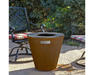 Arteflame One Series 20" Corten Steel Wood Fire Grill on outdoor patio surrounded by wrought iron garden chairs