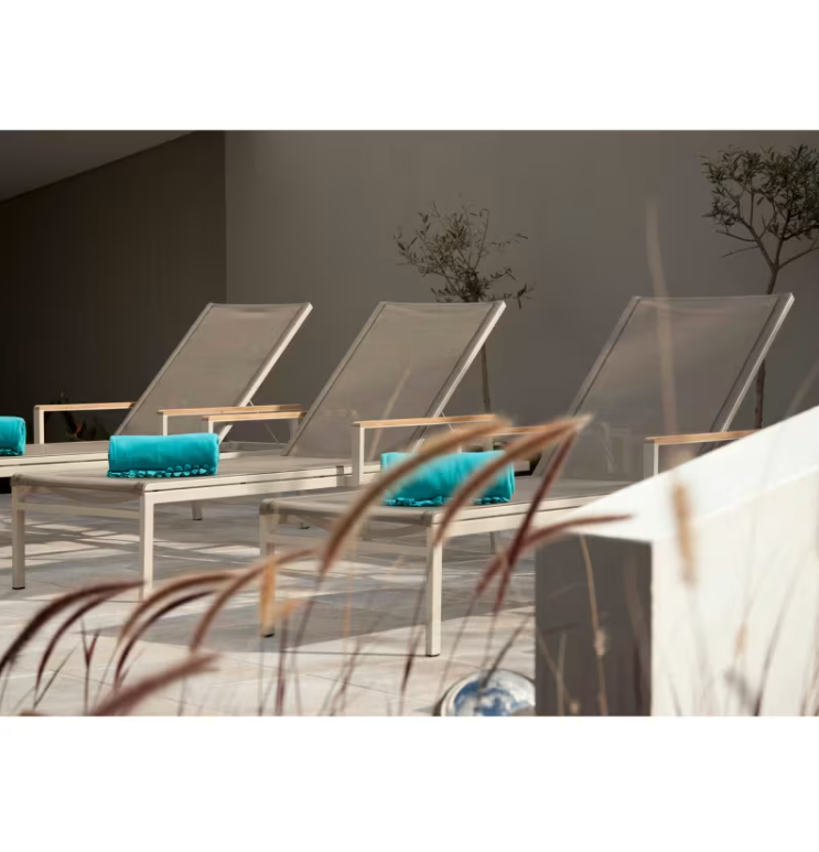 Barlow Tyrie Aura sling chaise lounge arctic white frame pearl sling poolside outdoor patio lifestyle