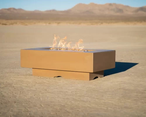 Del Mar concrete fire pit lit on a patio at dusk