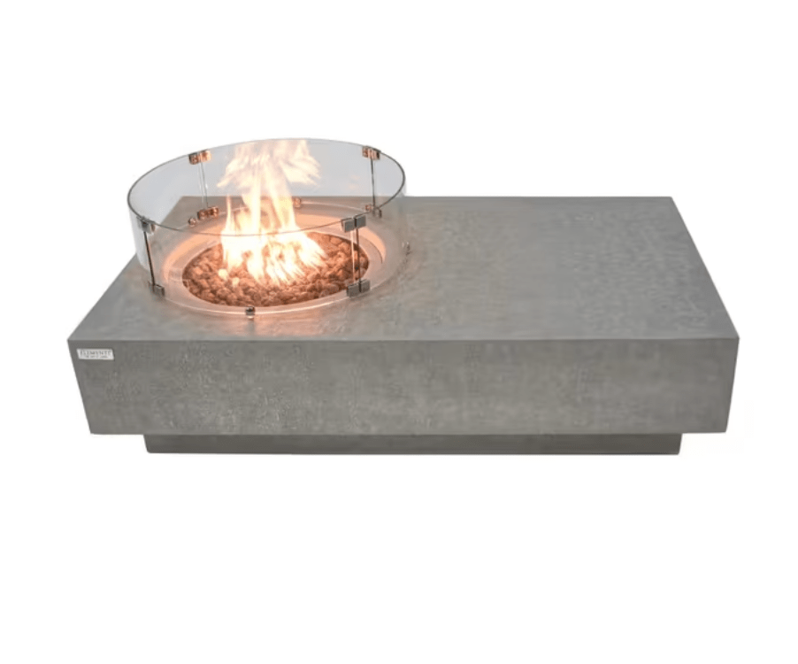 Elementi Metropolis 56" rectangular concrete gas fire pit table with lit flame and glass wind screen