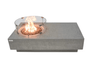 Elementi Metropolis 56" rectangular concrete gas fire pit table with lit flame and glass wind screen