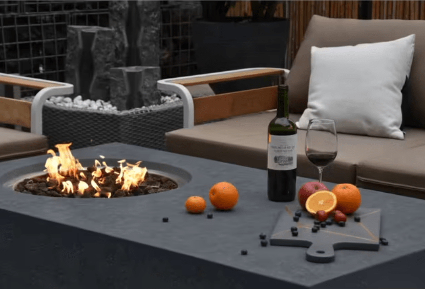 Elementi Metropolis rectangular fire pit table with flames lit outdoors