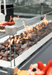 Elementi Granville fire pit table with flames and rocks, surrounded by a glass barrier