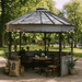 Sioux Steel grain bin gazebo with string lights, hanging plants, and rustic dining setup — ideal outdoor seating area for STR properties and event venues