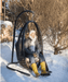 man resting in the heri hanging chair during winter