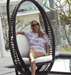 woman lounging comfortable in heri hanging chair