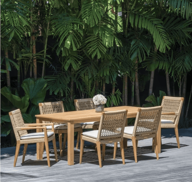 Kingsley Bate Barcelona Bainbridge 7-piece teak dining set with woven chairs and white cushions on deck