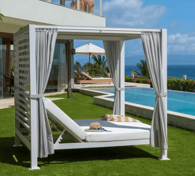 Pavilion Outdoor daybed with curtains by a pool and ocean view
