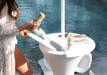 Opening the split lid of a Ledge Lounger Autograph Umbrella Stand Ice Bin to reach chilled cans poolside