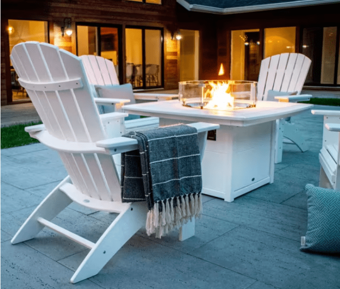 White POLYWOOD Nautical Curveback Adirondack chairs surrounding fire pit table, outdoor patio seating