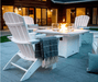 White POLYWOOD Nautical Curveback Adirondack chairs surrounding fire pit table, outdoor patio seating