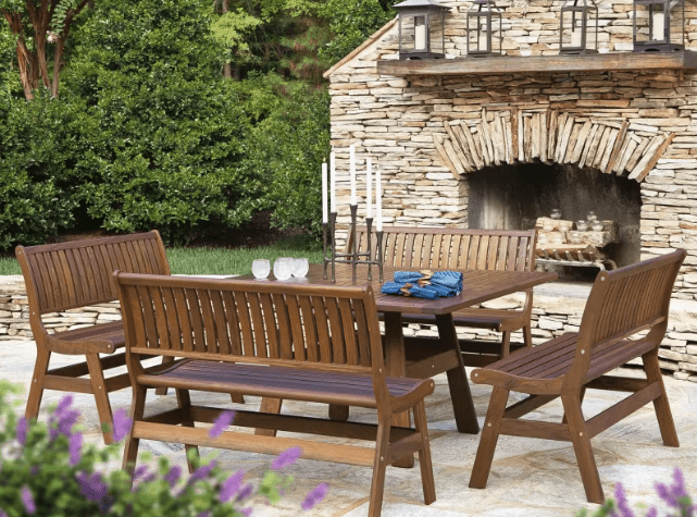 Jensen Outdoor Heritage 5-Piece Outdoor Dining Set in brown poly lumber with backed benches on stone patio