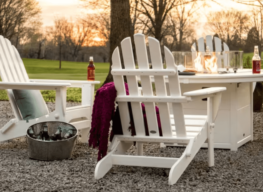 POLYWOOD Classic Folding Adirondack chairs ariund a fire pit table in an outdoor patio seating