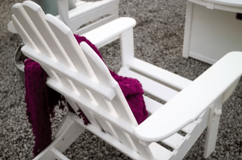 White POLYWOOD Classic Folding Adirondack chair close-up, slatted back detail
