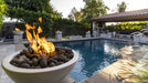 Fire pit with flames by a poolside in a backyard setting