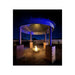 Grain bin gazebo with blue LED lighting and central fire pit at night — a dramatic outdoor feature for STR properties