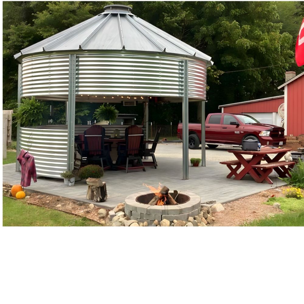 Sioux Steel grain bin gazebo with outdoor dining, fire pit, and string lights — perfect gathering spot for Airbnb and STR properties