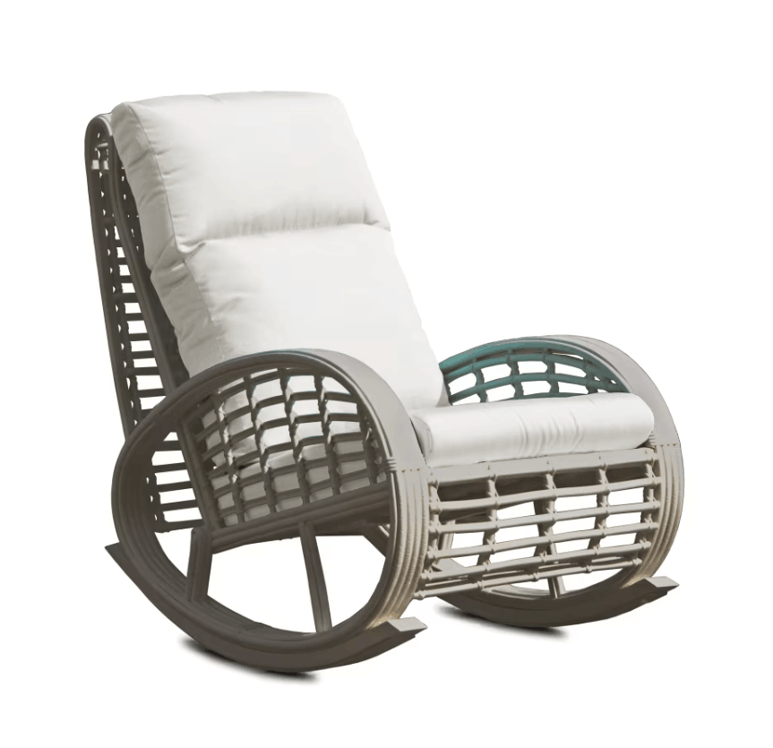 A modern outdoor rocking chair with a gray wicker frame, white cushions, and a small green accent on the right armrest, shown on a white background.