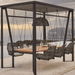 A large outdoor swing cabana with a suspended dining table and six hanging woven chairs, set on a patio overlooking a scenic ocean and mountain view.