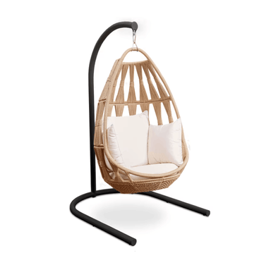 A teardrop-shaped woven rattan hanging chair with cream cushions, suspended from a black metal curved stand on a white background.