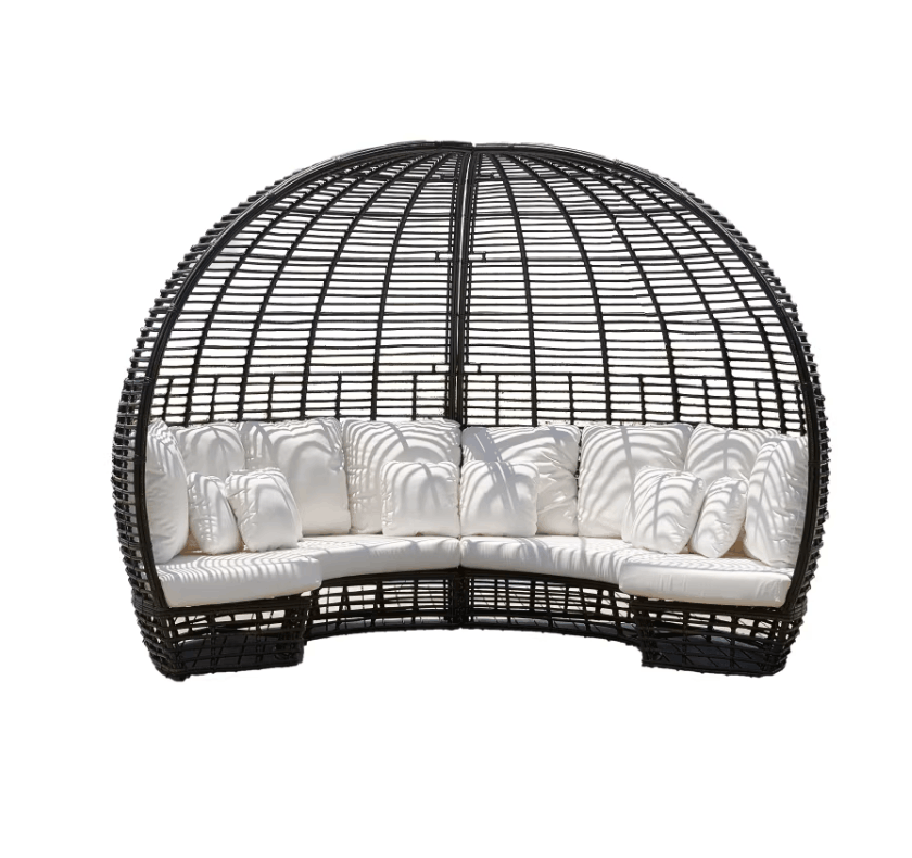 A black wicker egg daybed with plush white cushions, isolated on a white background.