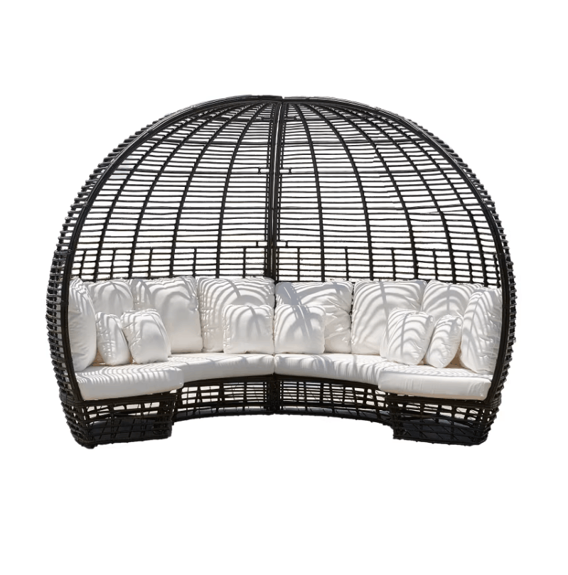 A black wicker outdoor daybed with a curved, dome-like structure and thick white cushions, shown against a plain white background.