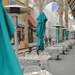 Sunglo freestanding propane patio heaters in use commercial outdoor dining patio with umbrellas and tables