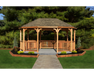 YardCraft 12x18 wood oval cedar gazebo kit in backyard garden setting