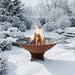 Arteflame Classic 40 inch corten steel fire pit burning in a snow-covered garden in winter
