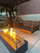 Customer photo: A&L Poly Traditional swing bed in Tudor Brown hung from a backyard pergola, with a lit fire pit in the foreground