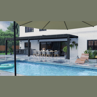 Equinox pergola with louvers closed in heavy rain, keeping the patio dining area and outdoor kitchen covered