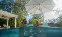 Ledge Lounger Ultra cantilever umbrella over in-pool seating